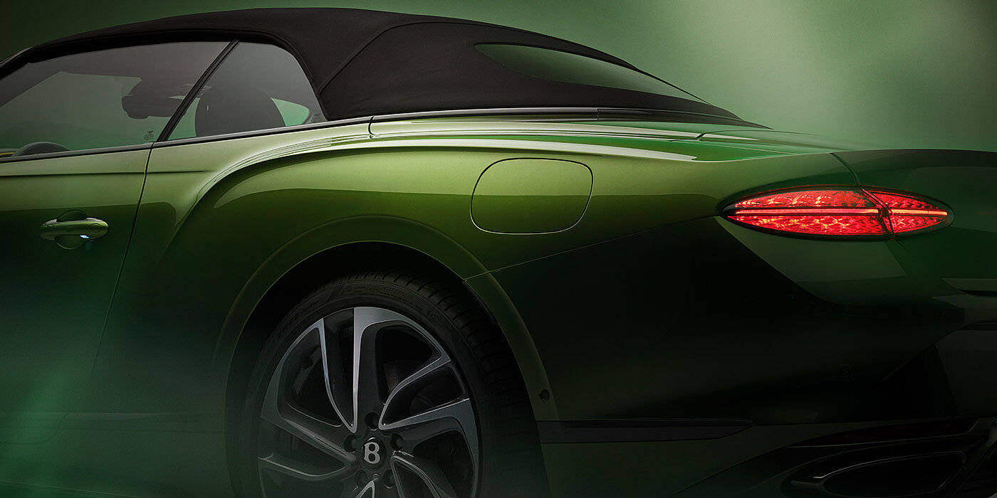 Bentley Adelaide Bentley New Continental GTC Speed rear haunch and tail lamp in Tourmaline Green paint and dark tint brightware with black hood up and illuminated head lamps