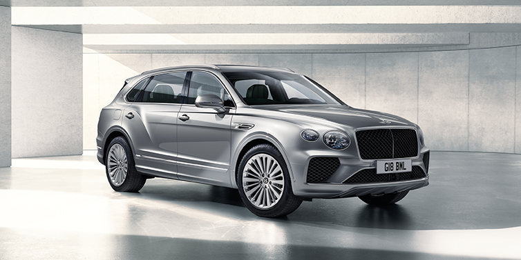 Bentley Adelaide Bentley Bentayga Extended Wheelbase SUV front three quarter in Moonbeam paint with a grey background